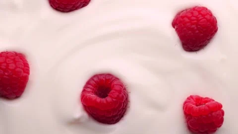 Fresh raspberry in white yogurt, rotation in circle. red berry in yogurt Stock Footage 252796598