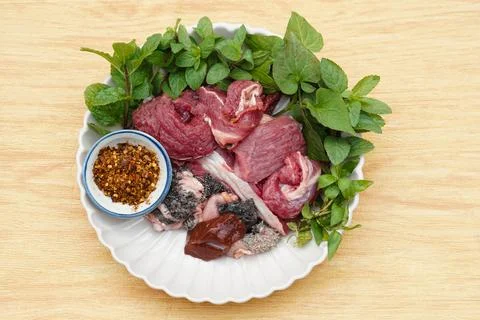 Fresh raw beef and Thai local herbal vegetables, prepare for cooking. Stock Photos