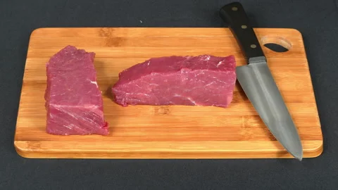 Fresh Raw Beef Cuts and Chef Knife on Wooden Board Video stock 343259723