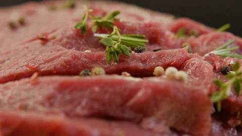 Fresh raw beef meat close-up with seasonings - peppers, salt. Stock-Footage 90495417