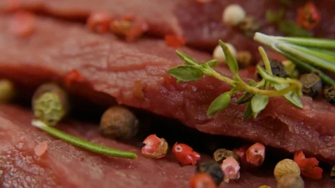 Fresh raw beef meat close-up with seasonings - peppers, salt. Preparation for Stock Footage 90495439