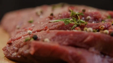 Fresh raw beef meat close-up with seasonings - peppers, salt. Preparation for Stock Footage 90495478
