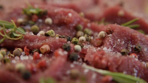 Fresh raw beef meat close-up with seasonings - peppers, salt. Preparation for Stock Footage 90495492