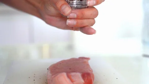 Fresh raw beef meat close-up with seasonings - peppers, salt. Preparation for Stock Footage 106691289