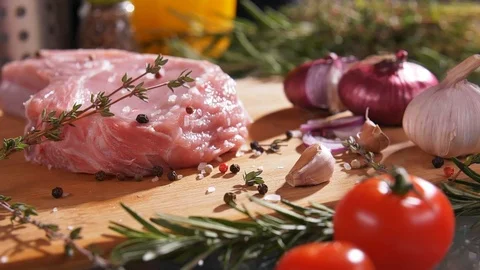 Fresh raw beef meat close-up with seasonings - peppers, rosemary,salt Stock Footage 107378978