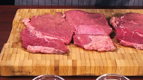 Fresh raw beef meat. Men seasons meat with oil, herbs and spice Stock Footage 66449078