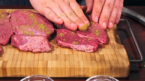 Fresh raw beef meat. Men seasons meat with oil, herbs and spice Stock Footage 66449121
