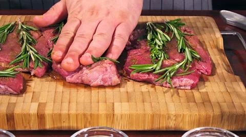 Fresh raw beef meat. Men seasons meat with oil, herbs and spice Stock Footage 66449651