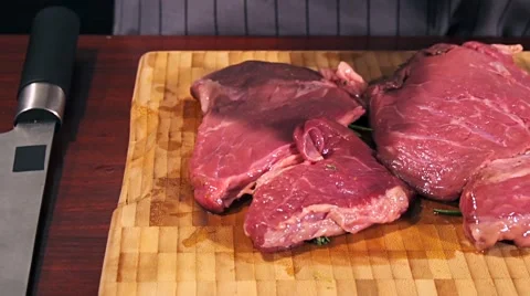 Fresh raw beef meat. Men seasons meat with oil, herbs and spice Stock Footage 66449913