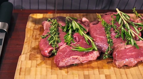 Fresh raw beef meat. Men seasons meat with oil, herbs and spice Stock Footage 66450080