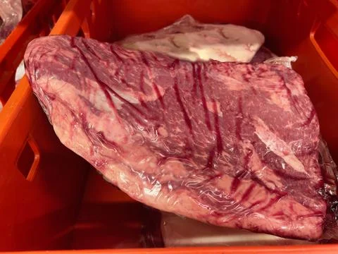 Fresh raw beef meat in a plastic box in a supermarket. Stock Photos