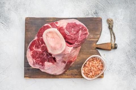 Fresh raw beef shank knuckle whole cut with bone styled with thyme and salt.. Stockfoto's