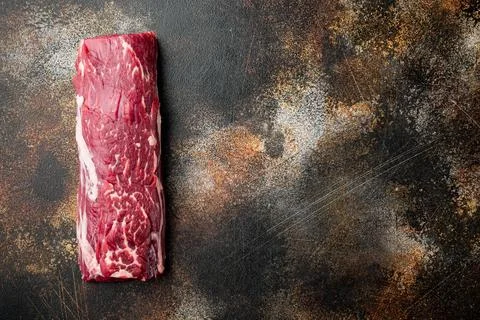 Fresh Raw Beef steak Mignon whole cut, on old dark rustic background, top vie Stock Photos
