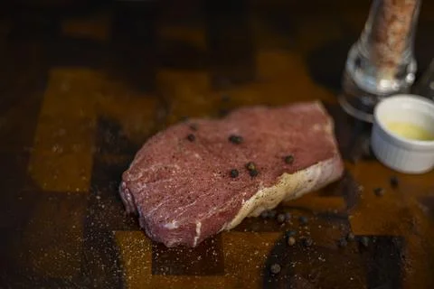 Fresh Raw Beef Steak With Rub On The Wood Board Stock Photos