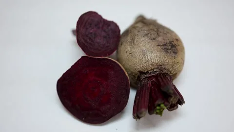 Fresh raw beetroot slice close-up studio shot on blurred white background Stock Footage 298176322