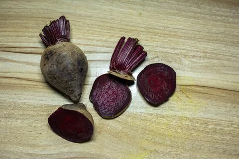 Fresh raw beetroot slice close-up studio shot on wood background 스톡 사진