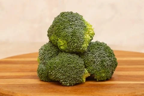 Fresh, raw broccoli cabbage close-up on a wooden board. Stock Photos