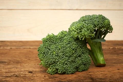 Fresh raw broccoli on a kitchen bench. Stock Photos