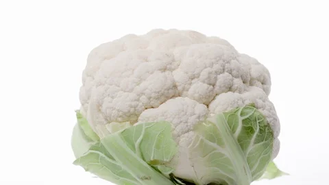 Fresh raw cauliflower rotating over white background Stock Footage 119619143