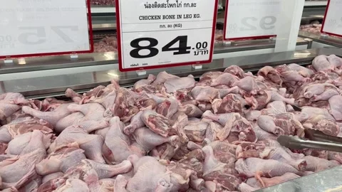 Fresh raw chicken bone leg on counter at Makro supermarket. Grocery shopping Stock Footage 244485066