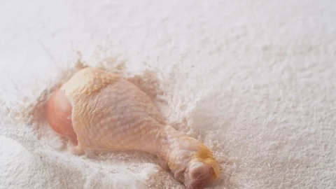 Fresh raw chicken drum dropped into flour. Slow Motion. Stock Footage 89812076