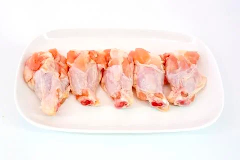 Fresh raw chicken wings isolate on white background ready to be grilled Stock Photos