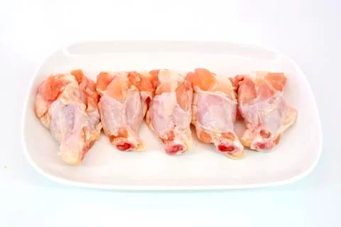 Fresh raw chicken wings isolate on white background ready to be grilled Stock Photos