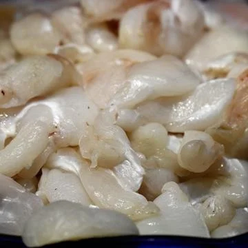 Fresh raw Cod cheeks on a fishmongers stall at a food market Stock Photos