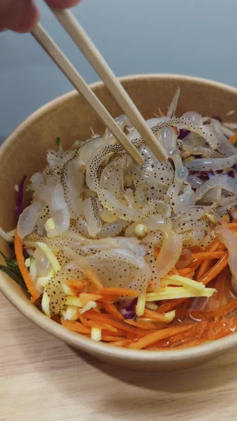 Fresh raw cuttlefish seafood salad with a mix of vibrant sliced vegetables Stock Footage 340962823