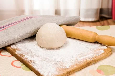 Fresh raw dough and rolling pin Stock Photos