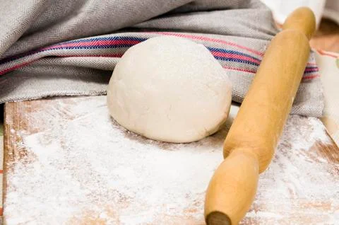 Fresh raw dough and rolling pin Stock Photos