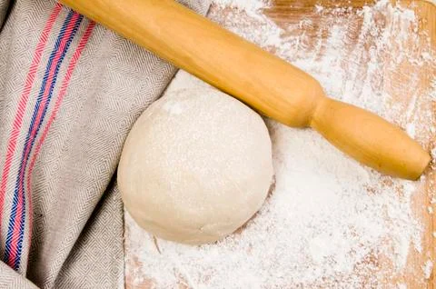 Fresh raw dough and rolling pin Stock Photos