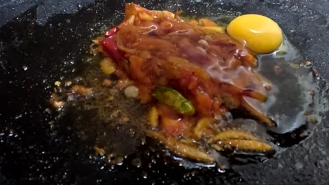 Fresh Raw Egg Cracking and Dropping on Spicy Tomato Onion Masala Stock Footage 341750643