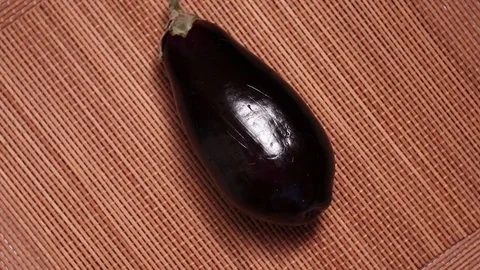 Fresh raw eggplants rotating Stock Footage 128764252