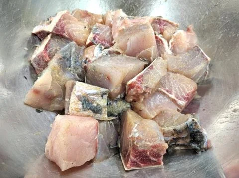 Fresh Raw Fish Cubes in a Stainless Steel Mixing Bowl for Cooking Stock-Fotos