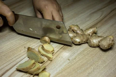 Fresh Raw ginger slice with knife Close-Up on wood board Background studio sh 写真素材