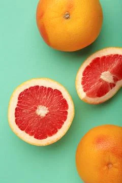Fresh raw grapefruit on mint background. Vertical photo Stock Photos