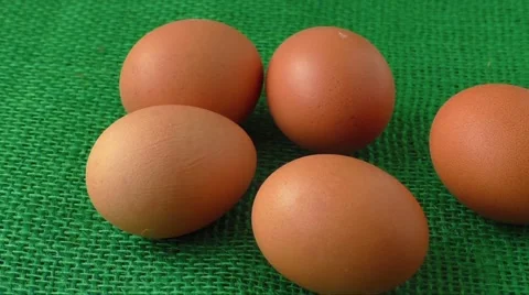 Fresh raw group of eggs put on green sack Stock Footage 60602967