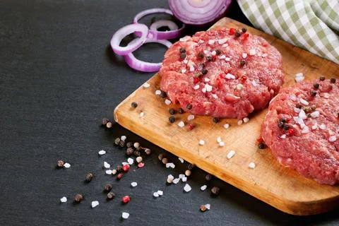 Fresh raw home-made beef burger cutlet Stock Photos