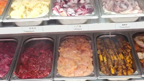 Fresh raw meat and seafood ingredients displayed in a Chinese hot pot buffe.. Video stock 339640220