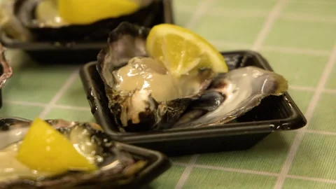 Fresh Raw Oyster with Lemon Slice at Tsukiji Fish Market Stock Footage 335498435