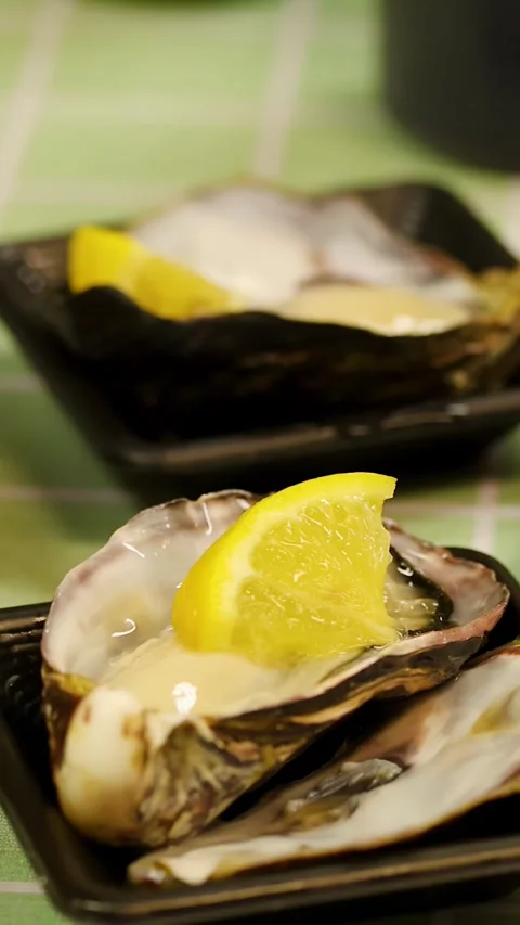 Fresh Raw Oysters with Lemon Squeezed by Hand in Tokyo Stock Footage 343837005