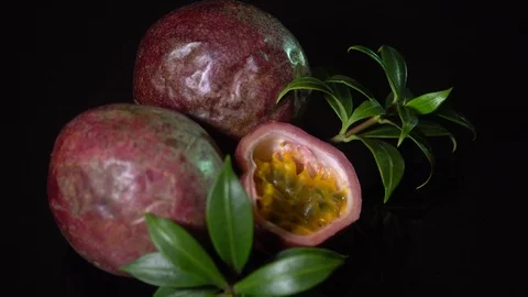 Fresh Raw Passion Fruit (Passiflora edulis) Rotating on Black Background Video stock 95935029