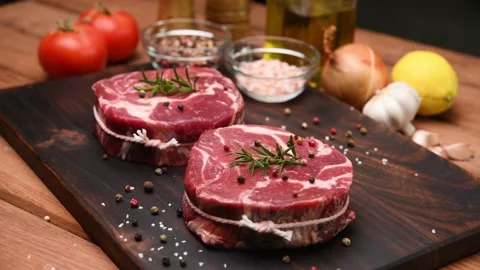 Fresh raw pieces of beef meat on a cutting board Видео 153008577