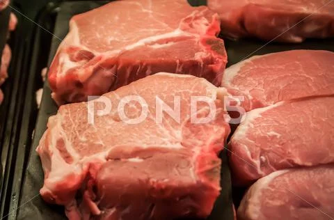 Fresh raw pork chops at the butcher Stock Photos