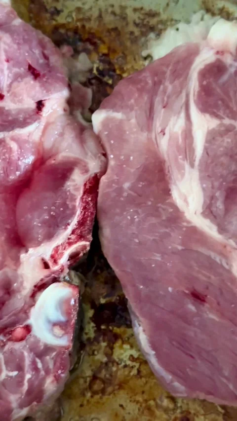 Fresh raw pork meat being seasoned with white salt Video stock 331973684