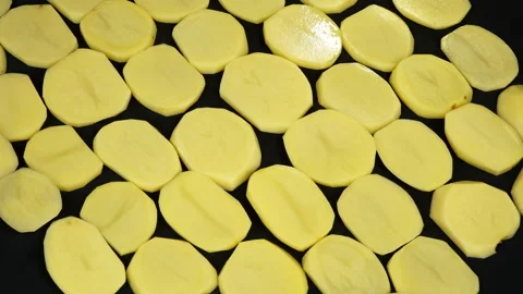 Fresh Raw Potato Slices Pattern Rotating on Black Background Stock Footage 344025312