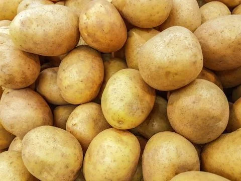 Fresh raw potatoes background Stock Photos