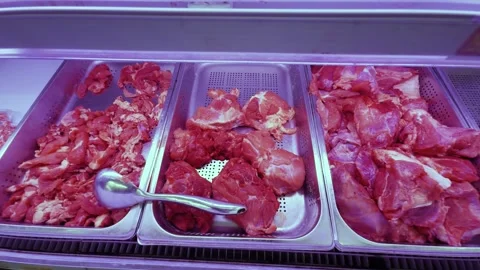 Fresh raw red meat cuts. Including pork and beef. Displayed in metal trays Stock Footage 344432014