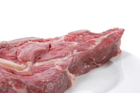 Fresh raw red ribeye beef steak on big white plate Stock Photos